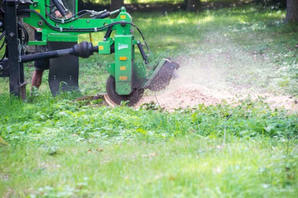 Professional stump grinding machine removing a tree stump below ground level during stump grinding and removal service in Florissant, MO.