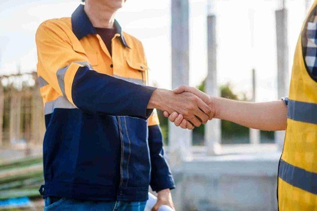 Florissant Tree Service representative shaking hands with a satisfied homeowner after completing professional emergency tree service in Florissant, MO.